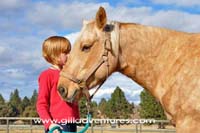 child and palomino horse